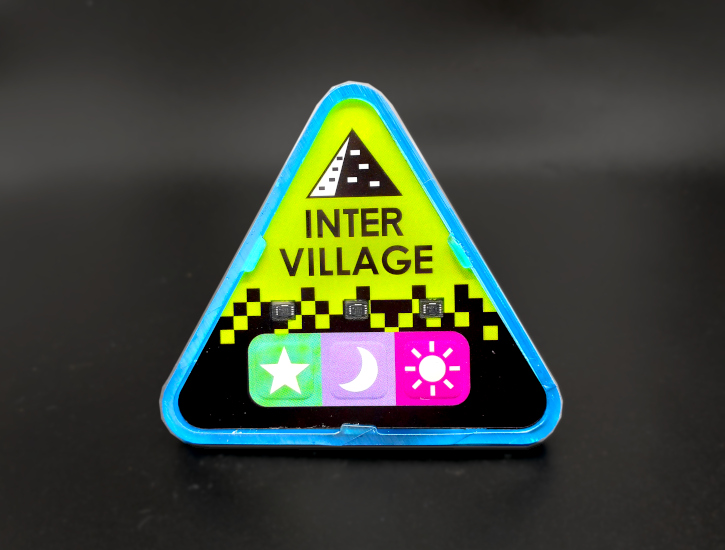 The Intervillage Badge front (Defense Blue model)